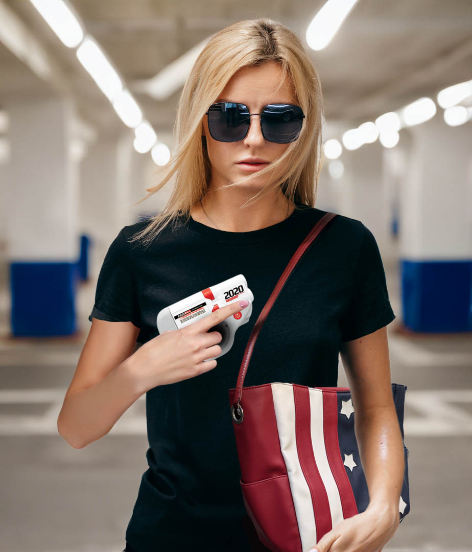 A woman holds her HERO 2020 with her MICHE handbag