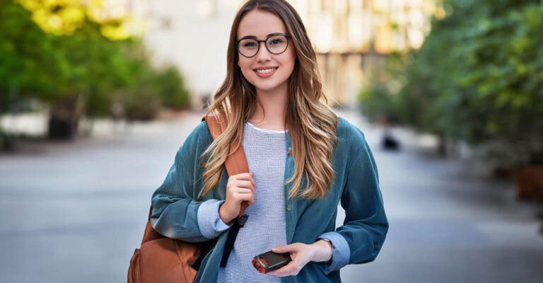 A college student holds her bag and an AIIRO non-lethal device