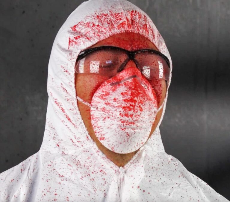 A man in protective gear who's been shot by AIIRO's red gel