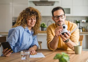 A couple looking over the instructions for setting up a security camera