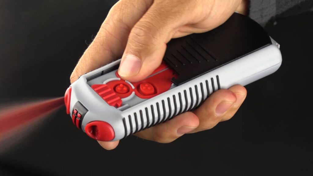 A closeup of AIIRO being deployed with the press of a button. Red gel is bursting from one of the barrels.